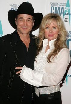 the man and woman are posing together on the red carpet