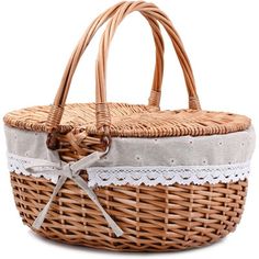 a wicker basket with white lace on the bottom and handles, sitting upright against a white background