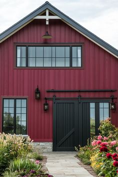 a red barn with black doors and windows