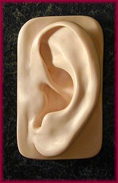 a white plastic ear sitting on top of a table