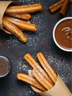 some churros and dipping sauce on a black table stock photo - 957982