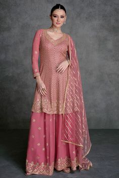 This Rose Pink Embroidered Georgette Sharara Suit showcases impeccable artistry. The anarkali top is embellished with intricate sequins, beads, and resham zari work embroidery. It comes with a heavily adorned georgette sharara bottom, featuring a four-sided lace border and a delicate net dupatta with sequins. Final Sale Fabric: Georgette Work: Embroidered Top Length: 36" Bottom Length: 40" Long sleeves 20" Elastic waist band Shape: Anarkali Lining on top & bottom Occasion: Party Wear, Wedding We Embroidery Kameez, Designer Sharara Suits, Anarkali Tops, Bridal Dupatta, Sharara Suits, Pakistani Style, Zari Embroidery, Palazzo Suit, Kurta Dress