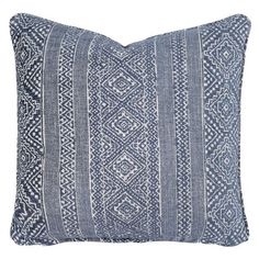 a blue and white pillow with an intricate design on the front, featuring horizontal stripes