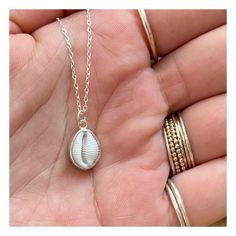 This beautiful necklace features an ethically sourced native cowrie shell in a custom made solid recycled silver setting with a silver chain.  Every necklace is handmade to order with the silver setting made custom for each shell, making each one unique.   There are two types of cowrie shell native to Cornwall, the European Cowrie ( Trivia monarcha ) and the Northern Cowrie ( Trivia arctica ).  The European cowrie is easily distinguishable from the Northern by the 3 dark spots on its shell and the fact it can grow to a larger size.  I find many cowries whilst beach-combing in Cornwall and they are one of the small number of shells I use in my jewellery. With my background in marine conservation I am acutely aware of the damage international trade in animal parts and shells inflicts on wild White Shell Jewelry Gift, Handmade Sterling Silver Shell For Beach, Sterling Silver Shell Pendant Necklace As Gift, Silver Shell-shaped Necklace For Gift, White Spiritual Shell Necklace, White Spiritual Shell Necklace As A Gift, Spiritual White Shell Necklace Gift, Nickel-free Shell Gift, White Sterling Silver Shell For Beach