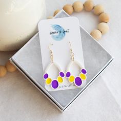 Stunning, one-of-a-kind Purple & Gold Polymer Clay Earrings, handmade with hypoallergenic 316 surgical steel ear wires for all-day comfort. Perfect for game days or any occasion, these lightweight earrings make a thoughtful gift for the special woman in your life. Stand out and make a statement with these vibrant and unique earrings. Handmade Yellow Teardrop Earrings, Handmade Yellow Teardrop Earrings Gift, Handmade Yellow Teardrop Earrings As A Gift, Yellow Beaded Earrings For Gift, Handmade Purple Earrings For Everyday, Handmade White Teardrop Earrings For Gift, Multicolor Beaded Pierced Earrings For Gift, Multicolor Beaded Pierced Earrings As Gift, Multicolor Beaded Earrings As Gift