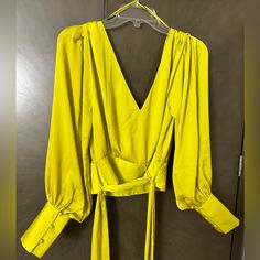 Beautiful Wrap Cropped Shirt. Brand New, Still With Tags. Yellow Long Sleeve Party Tops, Yellow Tops For Night Out In Fall, Yellow Tops For Fall Night Out, Yellow V-neck Top For Party, Yellow V-neck Top For Night Out, Chic Yellow Blouse For A Night Out, Elegant Yellow Tops For Night Out, Elegant Yellow Top For Night Out, Chic Yellow Cropped Blouse