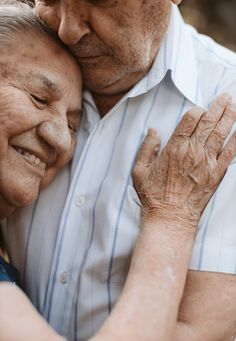 an older man and woman embracing each other