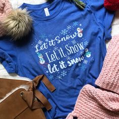 a blue shirt that says let it snow, let it snow and some other items