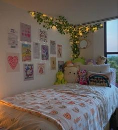 a bedroom with lots of stuffed animals on the bed and plants growing over the headboard