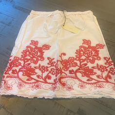 Super Sharp Looking White Skirt With Red Flower Pattern. Fully Lined With Elastic Waist Casual Red Bottoms With Floral Embroidery, White Floral Embroidered Skirt, White Short Skirt For Vacation, Red Lined Skirt Bottoms For Summer, Red Lined Skirt For Summer, Flowy Skirt With Floral Embroidery In White, Red Floral Embroidery Skirt For Spring, Flowy White Skirt With Floral Embroidery, Red Skirt For Summer Holidays