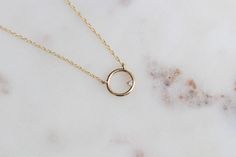 This necklace makes a great gift! Our open circle necklace is perfect for every day wear. -Diamond Measures 1.3mm -Open Circle Pendant measures 12mm in diameter -Handcrafted out of 14K Yellow, Rose or White Gold -Finished with a spring clasp -Pendant is attached to a beautiful dainty rope chain. -Choose 14, 15, 16, 17 or 18 inches in length -Model is wearing a 14 inch chain. Processing Times - Current processing time is 1 - 4 weeks. Each Item is handmade to order with love and care! In Stock Ite Minimalist Halo Necklace, Round Birthstone Necklace For Everyday, Everyday Round Halo Jewelry, Elegant Circular Birthstone Necklaces, Elegant Birthstone Circle Necklaces, Minimalist Halo Necklace For Gift, Minimalist Halo Necklace As Gift, Minimalist Halo Necklace For Gifts, Elegant Birthstone Necklaces