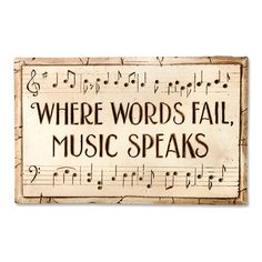 a wooden sign that says where words fail music speaks with musical notes in black and white