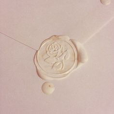 a wax stamp with a rose on it