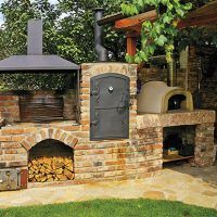 an outdoor pizza oven in the middle of a yard