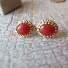 Salmon Red, Sometime Referred to as Sardinian (in color) Gemstone Coral Cab aka Cabochon set in 14k Yellow Textured Gold Pierced Stud Elegant Earrings, Stamped 14k. Everyday Gem Coral & Fine Gold Jewelry, Italian Coral likely (meaning not Asian), good overall condition, the coral has natural markings within the cabochon stones, so they are not flat solid orange, that is how we know they are genuine coral. Perfect size studs with just the right flash of color.  Remember the Victorians put coral on everyone as it was used as protective power against the evil eye and such... 13 MM or 1/2 IN x 11.3 MM or 7/16 IN Stamped 14k  Oval Shape  2.7 grams total weight Studs  They didn't have backs, so I added the ones that fit best, I think they are gold fill Red or Salmon Color  I believe they are Ita Elegant Red Earrings With Polished Finish, Elegant Red Jewelry With Cabochon, Elegant Red Cabochon Jewelry, Classic Red Jewelry With Matching Earrings, Red Classic Jewelry With Matching Earrings, Classic Red Round Jewelry, Red Polished Fine Jewelry Earrings, Classic Red Gemstone Jewelry, Red Polished Finish Fine Jewelry Earrings