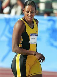 a woman in a yellow and black suit on a track