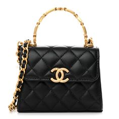 This is an authentic CHANEL Lambskin Enamel Quilted Mini Top Handle Flap in Black. This chic bag classic is crafted of soft quiltedlambskin leather in black. It features a gold chain top handle with black and white resin beads, a gold chain link leather threaded shoulder strap and a facing gold Chanel CC logo. This flap opens to a black leather interior with pockets. Chanel Small Flap Bag With Top Handle, Chain Top, Gold Chanel, Chanel Shoulder Bag, Mini Top, Leather Thread, Chic Bags, Resin Beads, Cc Logo