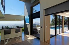 Modern high ceiling glass wall indoor outdoor west coast style luxury LA home remodel. Brunch Bar, Modern Home Designs