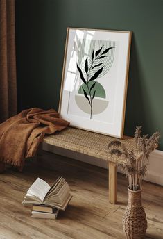 there is a book on the floor next to a table with a plant in it