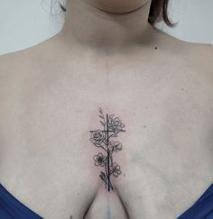 a woman's chest with a flower tattoo on her left side and the upper part of her stomach