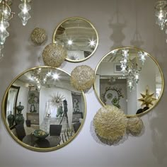 three circular mirrors hanging on the wall