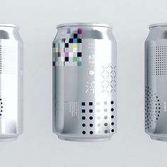 three cans of soda with different colors and patterns on the top one is silver, the other is white