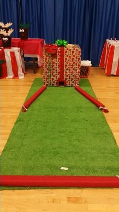 a green carpeted area with presents on it