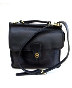 before you is an  classic,  crossbody,  willis station,   coach bag made in the United States of black leather with brass findings.       this well loved,  vintage bag would work well for around town or a day of shopping,   easy and breezy with just the right amount of storage.     this  turn lock,  top handle,  station bag  is classic coach,     timeless.       at about 10.5 inches wide and 10 inches tall,  with a  44 inch strap that is detachable and adjustable.  the turn lock works well. Classic Satchel With Brass Hardware In Tote Shape, Classic Tote Satchel With Brass Hardware, Classic Satchel Tote With Brass Hardware, Classic Satchel With Brass Hardware, Vintage Satchel Briefcase With Gold-tone Hardware, Classic Crossbody Satchel With Brass Hardware, Classic Vintage Black Bag For Everyday Use, Classic Vintage Black Bag For Daily Use, Classic Vintage Black Bag For Everyday