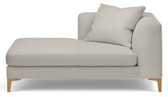 a white couch with two pillows on it