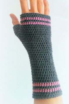 a woman's hand wearing a gray and pink arm warmer