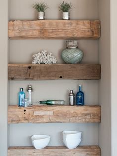 three wooden shelves with vases and other items on them