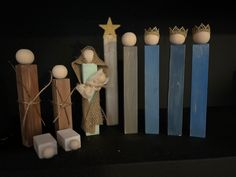 some candles are sitting on a table next to wooden sticks and other items that look like nativity