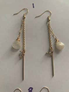 Enhance your look with our Dainty Spike Drop Earrings. These double-strand hanging earrings feature a striking spike and gem dangle accents on one strand, complemented by a delicate crystal drop on the shorter strand. Designed to sit beautifully on the ear, these earrings add a touch of elegance and sophistication to any outfit. Perfect for those who appreciate unique and refined jewelry. Dangle Crystal Earrings With Pearl Drop, Delicate Adjustable Dangle Linear Earrings, Adjustable Delicate Dangle Linear Earrings, Pearl Drop Dangle Linear Earrings, Chic Single Dangle Crystal Earring, Elegant Long Drop Crystal Earrings With Dangling Beads, Chic Single Crystal Dangle Earring, Chic Linear Dangle Earrings With Ear Wire, Chic Dangle Linear Earrings With Ear Wire