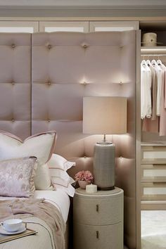 a bedroom with a bed, nightstand and closet