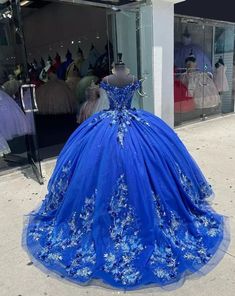 Make a grand entrance in this Royal Blue Ball-Gown Quinceañera Dress. This dress is crafted from layers of luxurious tulle and flows elegantly into a chapel train, adding to its regal charm. The off-the-shoulder neckline and sweeping ball gown silhouette create a majestic look, perfect for a special celebration. The exquisite appliques and shimmering beading embellish the bodice and skirt, enhancing the gown with intricate details and a touch of sparkle. The lace-up back allows for a beautifully Thirteen Party, Royal Blue And Gold Quinceanera, Royal Blue Ball Gown, Mini Twists Natural Hair, Royal Blue Quinceanera Dresses, Royal Blue Quinceanera, Quinceanera Dresses Gold, Gown Silhouette, Dresses With Appliques