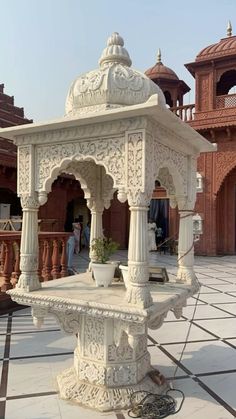 an ornate white fountain in the middle of a courtyard