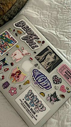 an assortment of stickers sitting on top of a bed