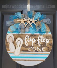 a door hanger that says flip flop zone with sandals and starfish on it