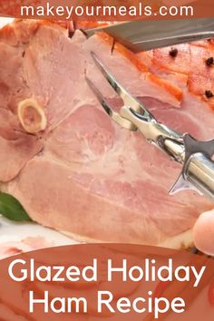 a person cutting ham on a plate with a pair of shears in front of it