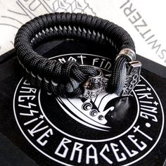 "Black Nordic paracord bracelet \"THOR'S HAMMER\". A gift for men. Scandinavian style, Celtic knot. Stylish handmade paracord bracelets for those who are always moving forward. These fashion accessories are made of extremely durable, scratch-resistant rope and original steel beads. These bracelets are ideal for both men and women. Each bracelet is precisely made by hand. The process of making one bracelet can take up to 50 minutes - it requires the closest attention to ensure the highest possibl Snake Tattoo Design, Mens Bracelets, Paracord Survival, Thor's Hammer, Viking Bracelet, Survival Bracelet, Viking Style, Paracord Bracelet, Paracord Bracelets