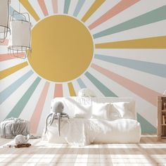 a living room with sunburst painted on the wall and white furniture in front