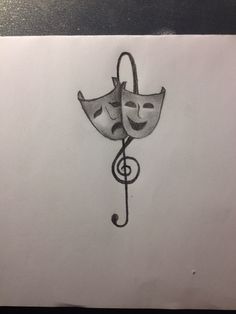 a drawing of two masks with musical notes on them