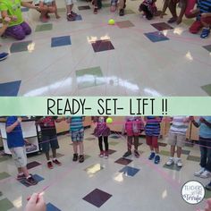 a group of children standing on top of a tiled floor with tennis balls in the air