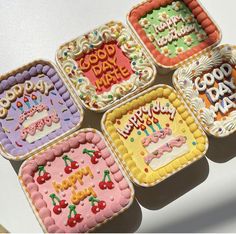 four decorated birthday cakes sitting on top of a table