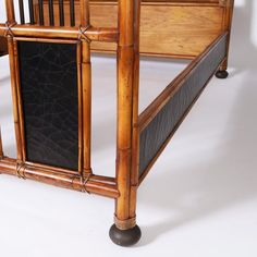 a bed frame made out of bamboo with black leather trimmings and wooden slats