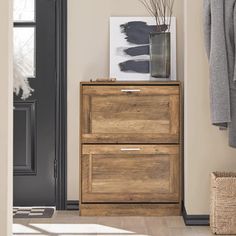 a wooden dresser sitting next to a door