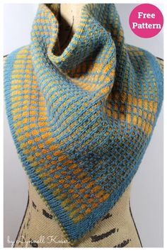 a blue and yellow knitted scarf on top of a mannequin