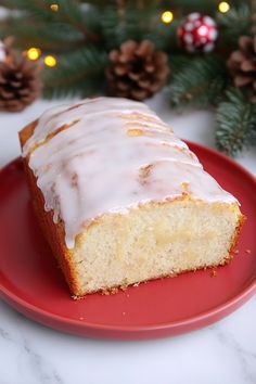 a piece of cake sitting on top of a red plate next to a christmas tree