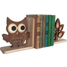 an owl figurine sitting on top of a book shelf