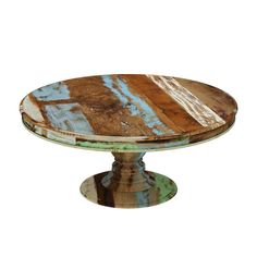 a round wooden table with blue and green paint on it's surface, against a white background